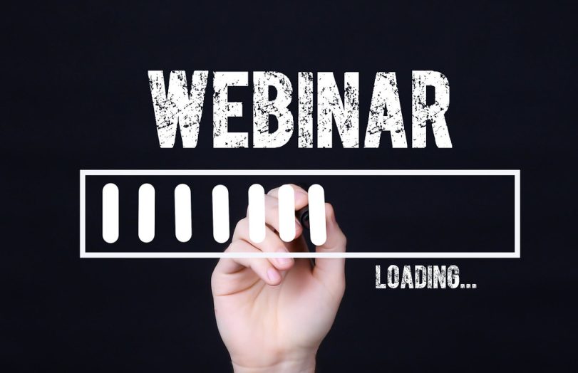 Black background with the word Webinar in white chalk above an image of hand making vertical chalk marks as is something was loading onto a computer.